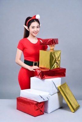 Asian elf woman holding Christmas gifts