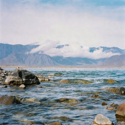 Mountain Lake with Rocks and Clouds