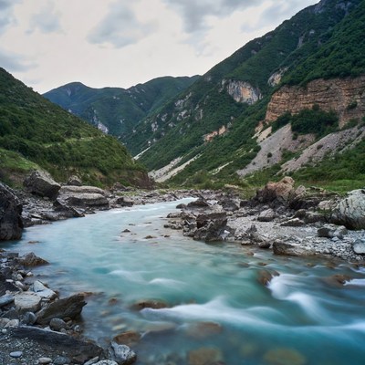 Turquoise River Flowing Through Green Mountains