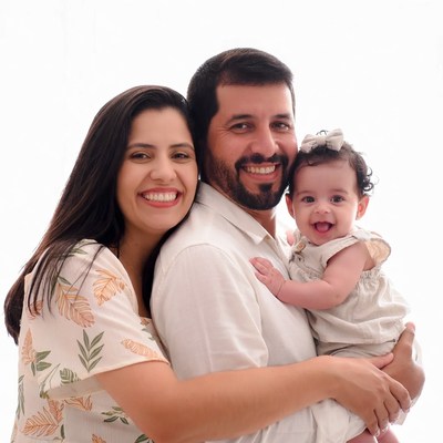 Smiling family with baby on white background