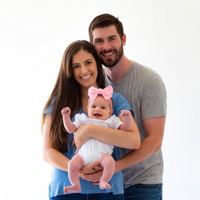 Family holding smiling baby girl