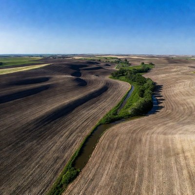 Aerial view of river through farmland