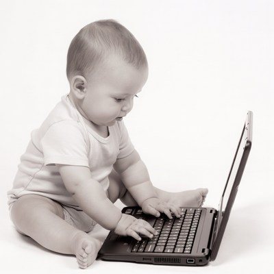 Baby typing on laptop