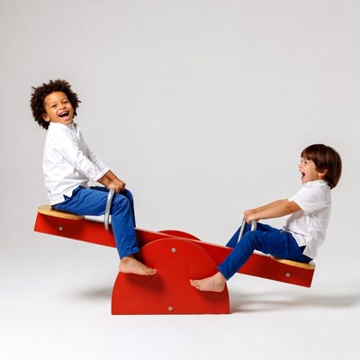 Two boys playing on red seesaw