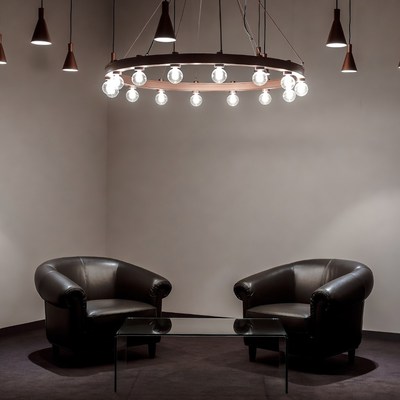 Modern Copper Chandelier Over Leather Chairs