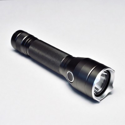 Black tactical flashlight on white background