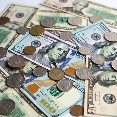 US Dollars and Coins Scattered