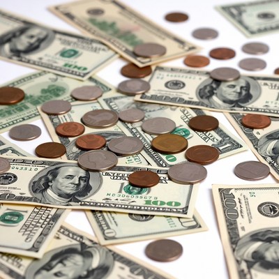 Scattered US Dollars and Coins