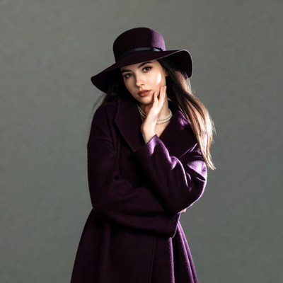 Woman in purple hat and coat