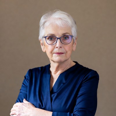 Elderly woman with arms crossed