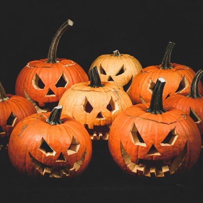 Jack-o'-lantern pumpkins on black background