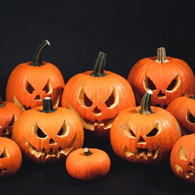 Jack-o'-lantern pumpkins on black background