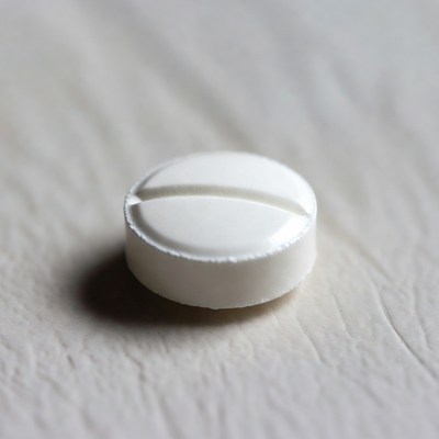 White pill on white surface