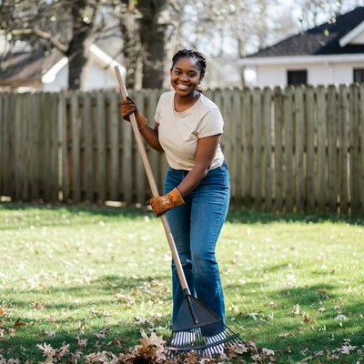 African-American woman raking leaves