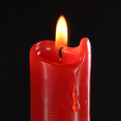 Burning Red Candle with Wax Dripping