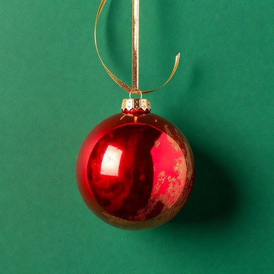 Red Christmas ornament on green background