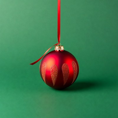 Red Glitter Christmas Ornament on Green Background
