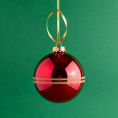 Red Christmas ornament on green background