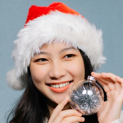Asian woman holding Christmas ornament