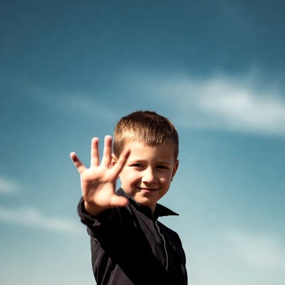 Boy making stop hand gesture