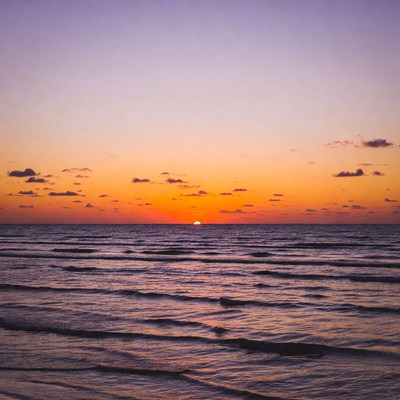 Sunset over calm ocean waves