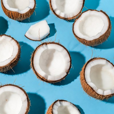 Fresh Coconut Halves on Blue Background