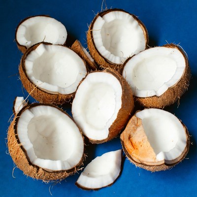 Fresh Coconut Halves on Blue Background