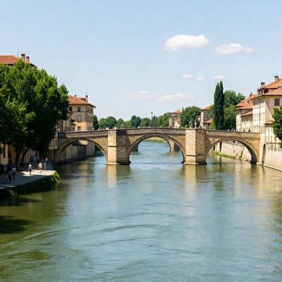 Stone Bridge over River with Buildings