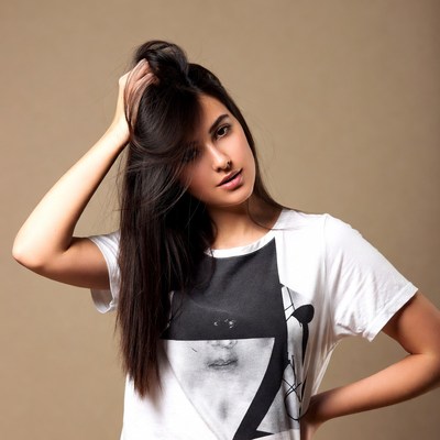 Young woman touching long black hair