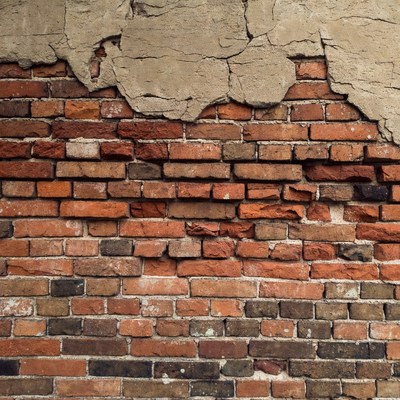 Peeling Plaster on Brick Wall