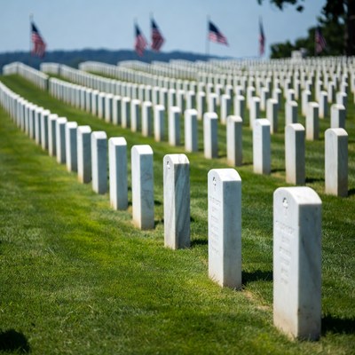Rows of White Headstones with American Flags
