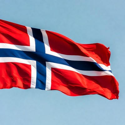 Norwegian flag waving against blue sky