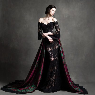 Woman in black lace gown with purple cape