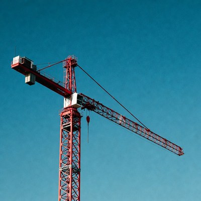 Red Construction Crane Against Blue Sky
