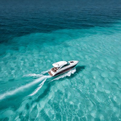 Speedboat racing through turquoise ocean