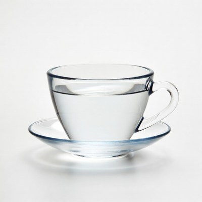 Clear glass teacup with saucer