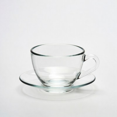 Clear glass teacup with saucer