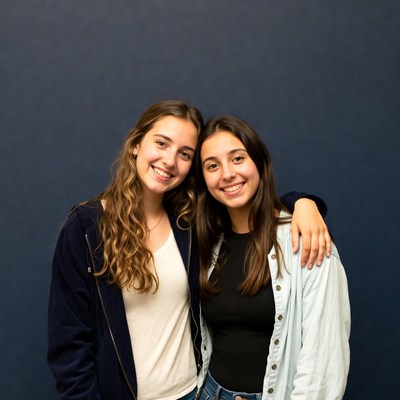 Two smiling teenage girls hugging