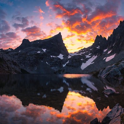 Sunset over mountains reflecting in lake