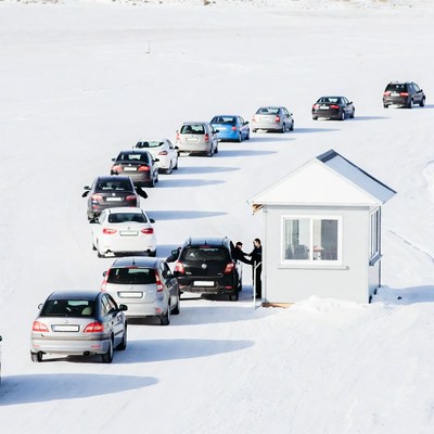 Cars queuing at snowy toll booth