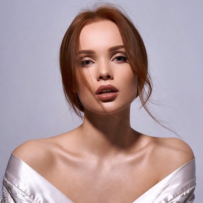 Redhead woman in white off-shoulder top