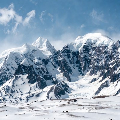 Snowy Mountain Peaks Under Blue Sky