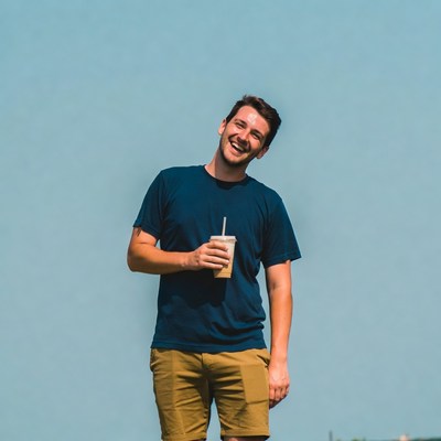 Smiling man holding iced drink