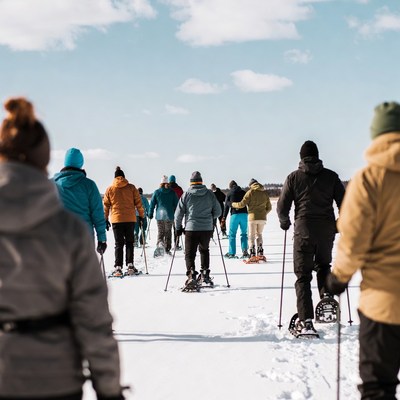 Group snowshoeing on snowy trail