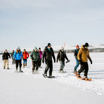 Group snowshoeing on frozen lake