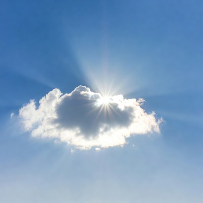 Sun shining through white cloud