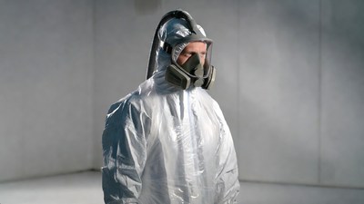 Man in hazmat suit and respirator