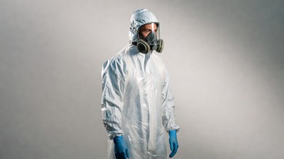 Man in hazmat suit with respirator