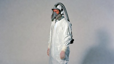 Man in hazmat suit with respirator
