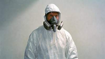 Man in hazmat suit and respirator